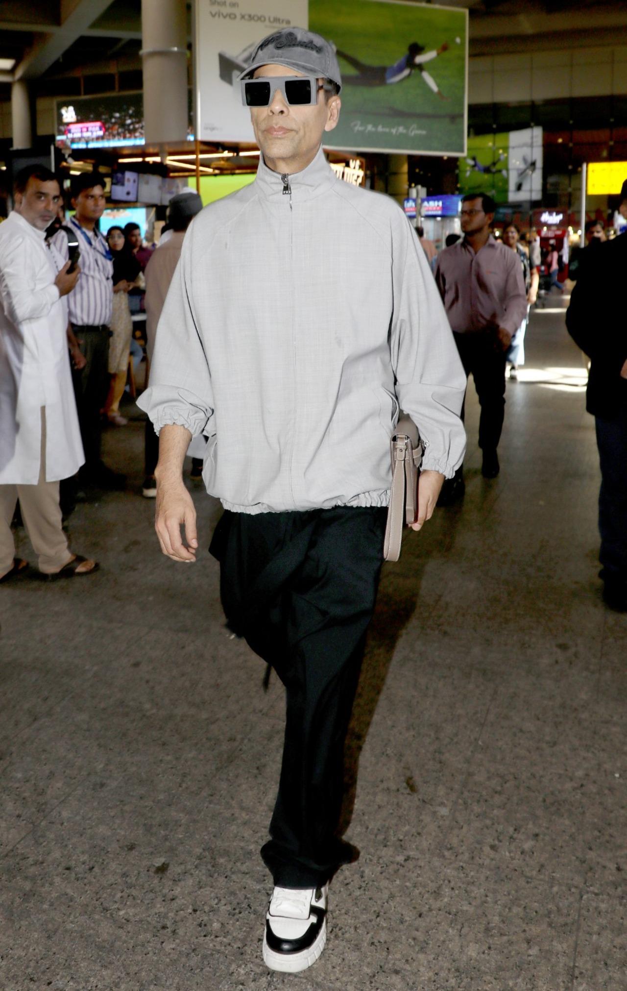 The filmmaker looked uber cool in a cream polo neck jacket over black track pants and sneakers. He completed his look with sunglasses and a cap.
